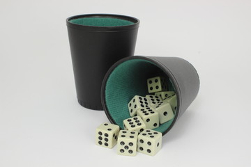 White dice with two black and green dice cups - isolated
