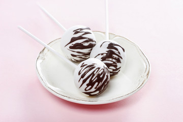 White cake pops decorated with dark chocolate
