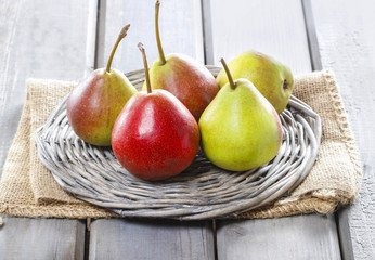 Fresh pears on wicker tray