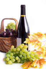 Ripe red and dark grapes and wine in basket