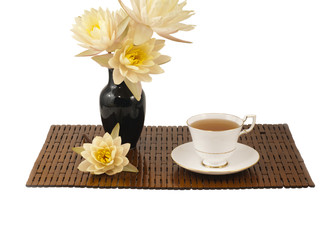Cup of tea on bamboo mat.