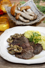 Roasted beef with mushrooms. Autumn table setting