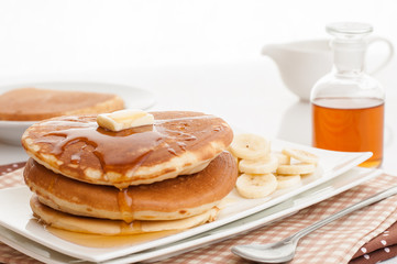 Pancakes with butter and syrup.