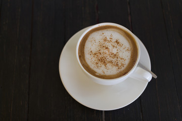 coffee cup on wooden board