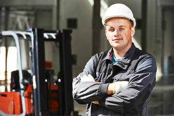 warehouse worker in front of forklift