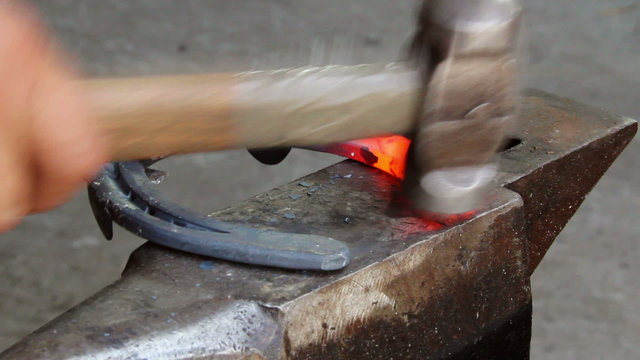 Blacksmith shaping a horseshoe