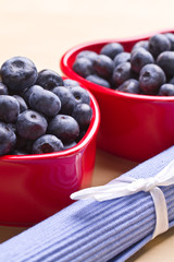 blueberries in a beautiful red heart-shaped bowls. full of vitam