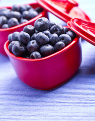 blueberries in a beautiful red heart-shaped bowls. full of vitam