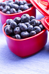 blueberries in a beautiful red heart-shaped bowls. full of vitam