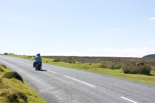 Couple Of Tourists On A Motorbike On Dartmoor, Uk