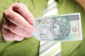 Businessman holding money 100 polish zloty