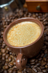 cup of black coffee on a background coffee beans, close-up