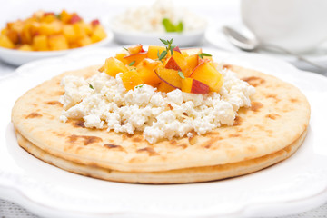 Flat bread with cottage cheese, honey, nuts, fresh peaches