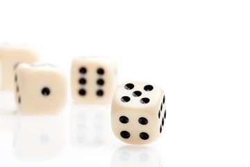 one dice in front of some dice unfocused