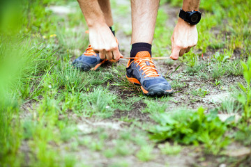 Runner tying sports shoe