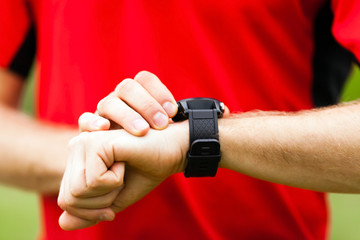 Runner looking at sport watch