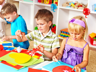 Child cutting out scissors paper.