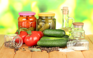 Tasty green cucumbers and red tomatoes in basket,