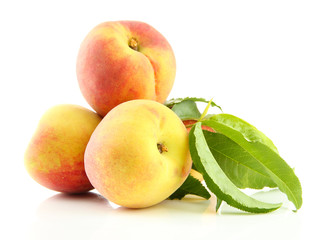 Ripe sweet peaches with leaves, isolated on white
