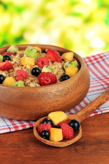 Oatmeal with fruits on table on bright background