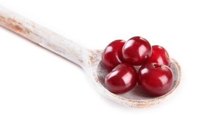 Cherry in wooden spoon isolated on white