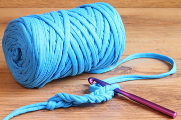 Blue zpagetti t-shirt yarn skein with a purple crochet hook