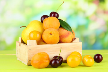 Bright summer fruits in wooden box