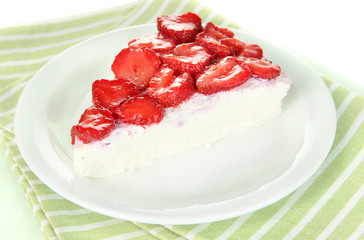 Cheesecake with fresh berries on white plate closeup