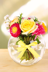 Beautiful bouquet of bright flowers in glass vase,