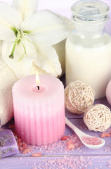 Beautiful spa setting with lily on wooden table close-up