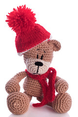 teddy bear with  scarf and bobble cap in winter