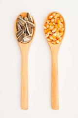Corn and sunflower seed on wood spoon