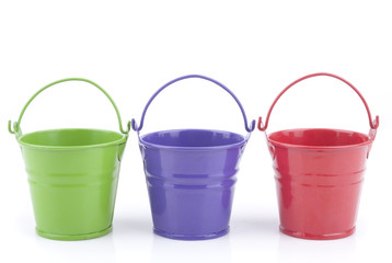 Three buckets of different colors, isolated on white background. © dibas99