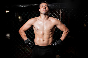 Fototapeta na wymiar Hispanic MMA Fighter in a cage