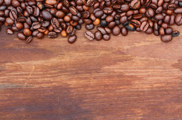 Fresh coffee beans on wood background