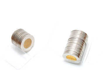 Fototapeta na wymiar Plastic roll holding two dollar coins