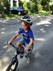 young boy with bicycle and helmet