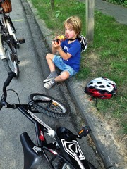 young boy with bicycle and helmet