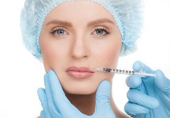 Botox injection. Portrait of beautiful young woman in medical he