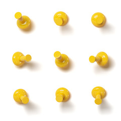 Set of yellow push pins with different angles isolated