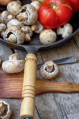 Mushrooms and fresh vegetables on the rusty pan