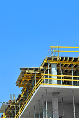 Building construction site work against blue sky