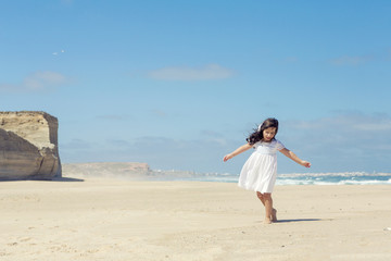 Fototapeta na wymiar Girl dancing on the beach