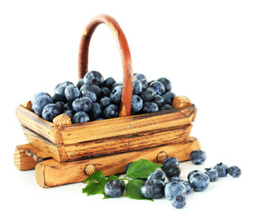 Blueberries in wooden basket isolated on white