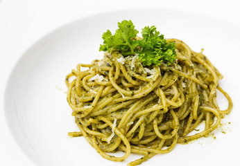 Italian pasta spaghetti with pesto sauce and basil leaf