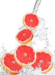 Fresh grapefruits falling in water splash, 