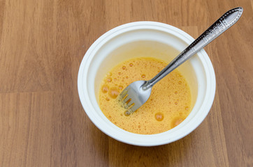 The beaten eggs in bowl for cooking omelet
