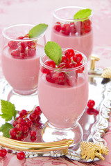Panna cotta dessert with red currants, selective focus.