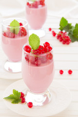 Panna cotta dessert with red currants, selective focus.