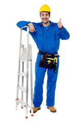 Plumber posing confidently with thumbs up
